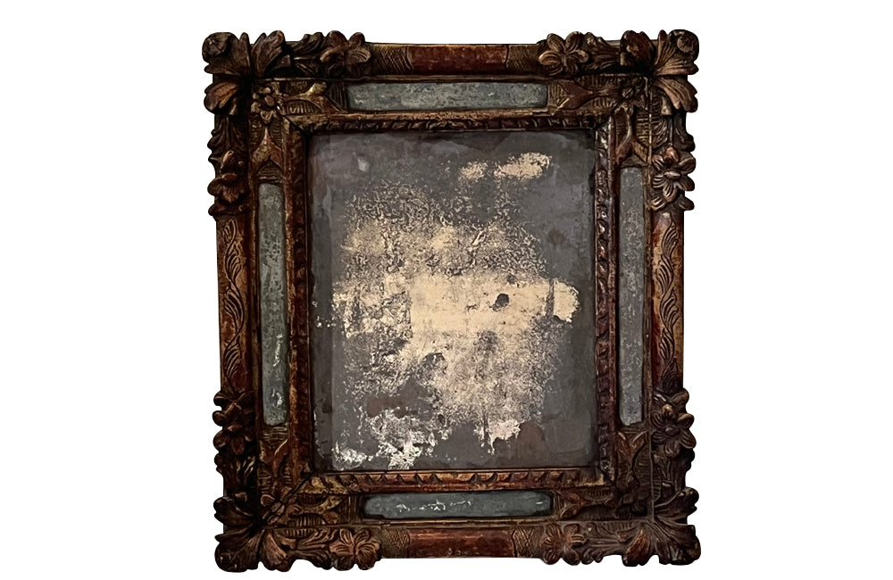 Beautiful early 18th Century French carved gilt wood cushion mirror with foxed glass