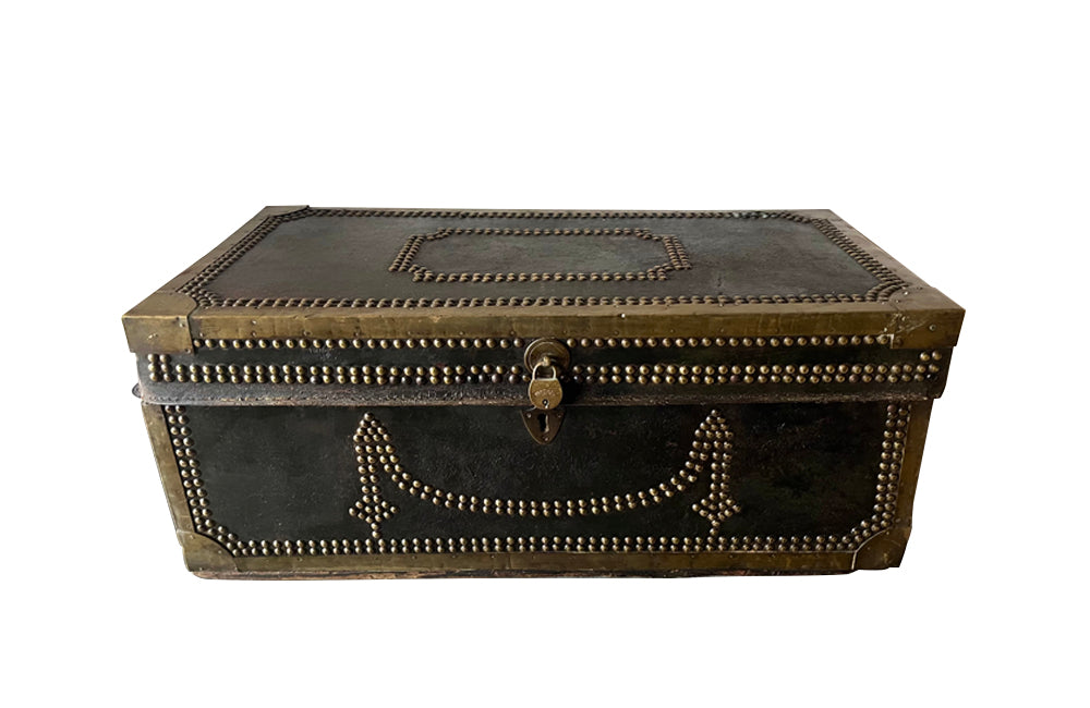 An early 19th century brass banded and studded leather trunk