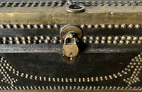 An early 19th century brass banded and studded leather trunk