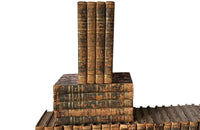 Early 19th century collection of thirty eight worn leather spined books with purple marbled paper covered boards.