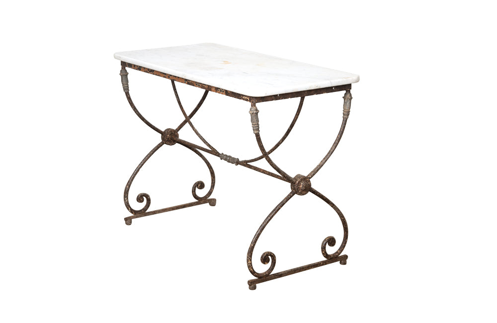 Beautiful 19th century French iron based table with lead medallions and ornamentation to arched stretcher and top of legs.