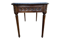 19th century walnut desk decorated with carved with Neo-Classical motifs to all sides.