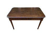 19th century walnut desk decorated with carved with Neo-Classical motifs to all sides.