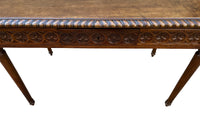 19th century walnut desk decorated with carved with Neo-Classical motifs to all sides.