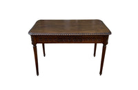 19th century walnut desk decorated with carved with Neo-Classical motifs to all sides.