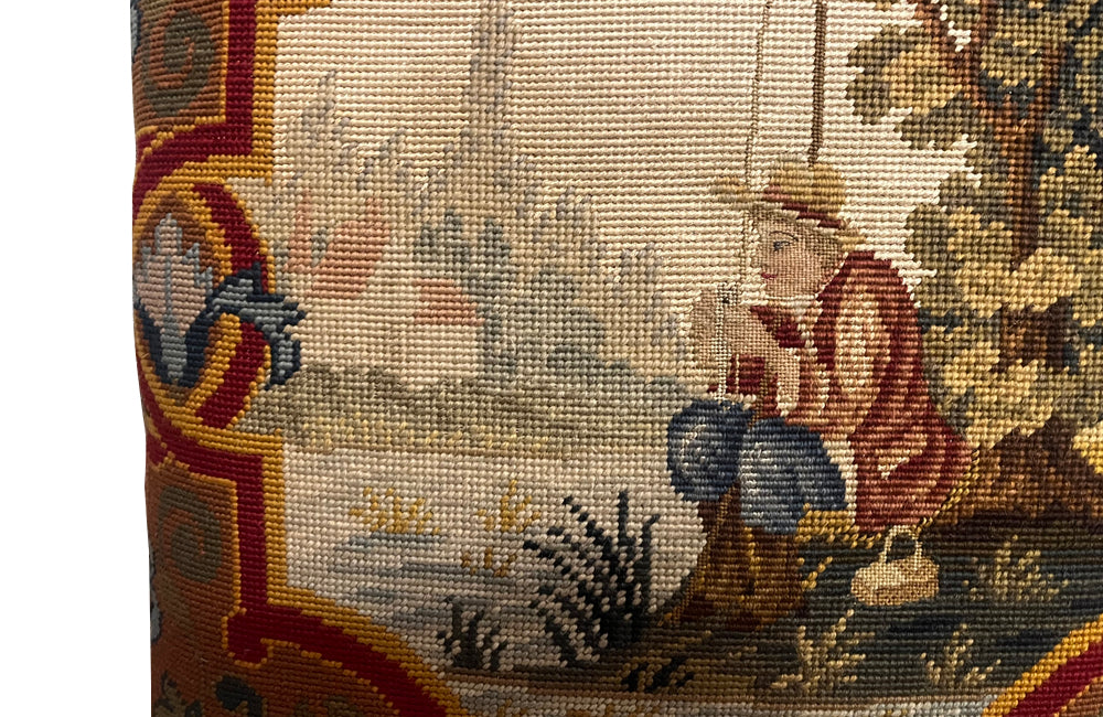 Antique cushion French tapestry cushion Depicting a fisherman in his straw hat, he sits on the banks of a river admiring his catch. To his side is a lidded basket. 19th century. French antiques.