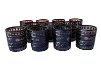 Set of eleven cut deep red glass whisky glasses.