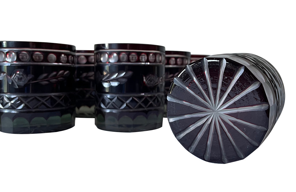 Set of eleven cut deep red glass whisky glasses.