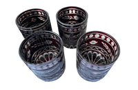 Set of eleven cut deep red glass whisky glasses.