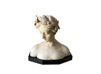 20th Century marble bust of a serene young woman with laurel wreath in hair and fine robe. 