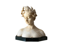 20th Century marble bust of a serene young woman with laurel wreath in hair and fine robe. 