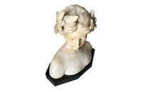 20th Century marble bust of a serene young woman with laurel wreath in hair and fine robe.