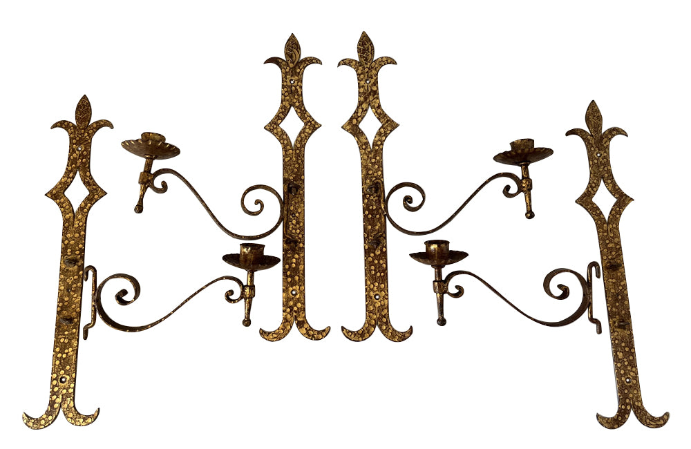 Set of 20th century Spanish decorative four gilt iron wall appliques.