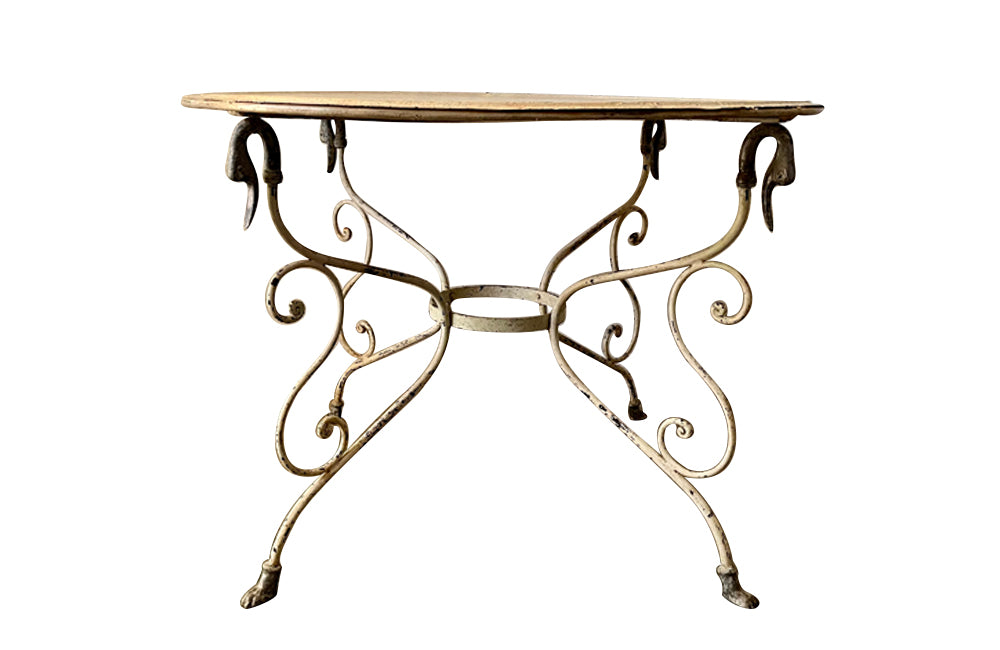 large 20th Century iron table supported on four swan topped curved legs terminating on webbed feet.&nbsp;