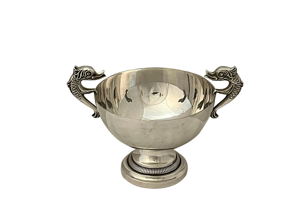 Decorative silver plate bowl with dolphin handles on raised foot and stamped with makers mark B.R.