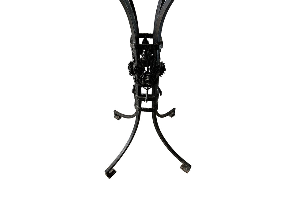Tall black iron Art Deco plant stand in the manner of Edgar Brandt. Rose ornamentation to all sides of support. Circa 1930