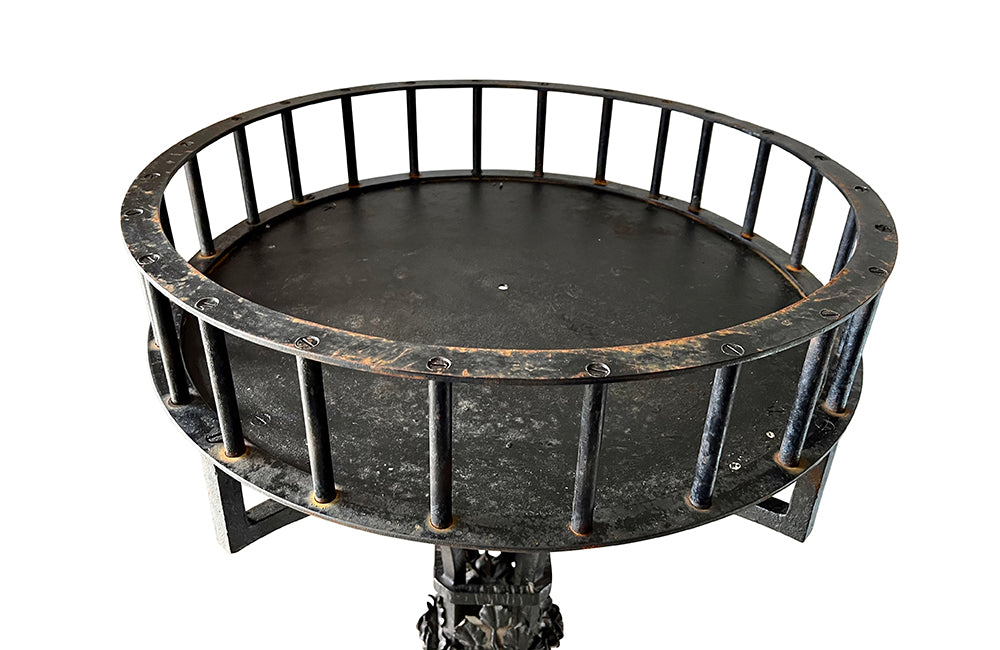 Tall black iron Art Deco plant stand in the manner of Edgar Brandt. Rose ornamentation to all sides of support. Circa 1930