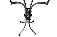 Tall black iron Art Deco plant stand in the manner of Edgar Brandt. Rose ornamentation to all sides of support. Circa 1930