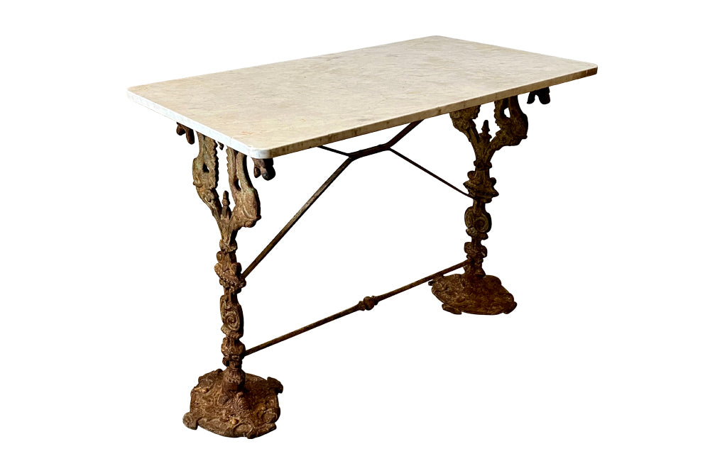 19th Century French bistro table with winged dragon supports and marble top. Great patination