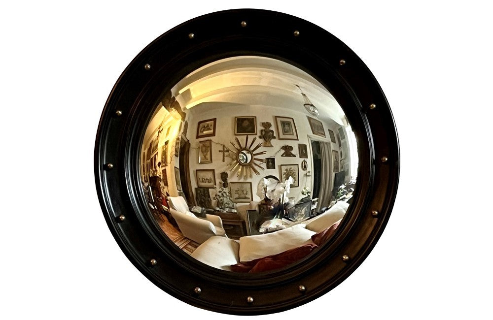 Stylish, round ebonised sorciere mirror decorated with brass balls to the surround.