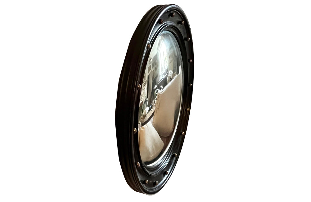 Stylish, round ebonised sorciere mirror decorated with brass balls to the surround.