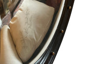 Stylish, round ebonised sorciere mirror decorated with brass balls to the surround.