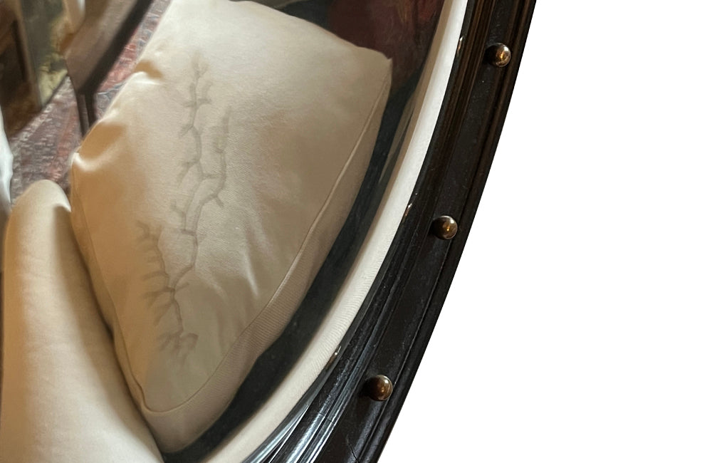 Stylish, round ebonised sorciere mirror decorated with brass balls to the surround.
