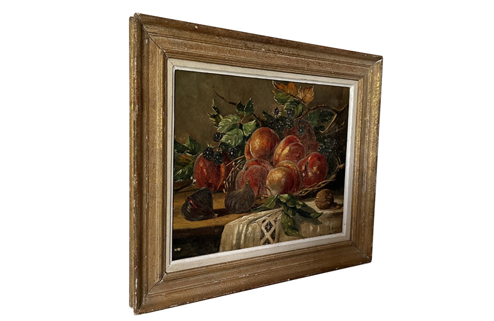Early 20th Century French framed still life oil painting of wild blackberries, peaches, figs, a walnut and a woven basket on a draped tablecloth. 