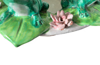 20th century glazed terracotta centrepiece in the form of a basket with seven open mouthed frogs on flowering water lily pads surrounding the rim.