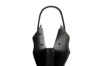 20th century stitched black leather with brass studs magazine holder by Jacques Adnet.