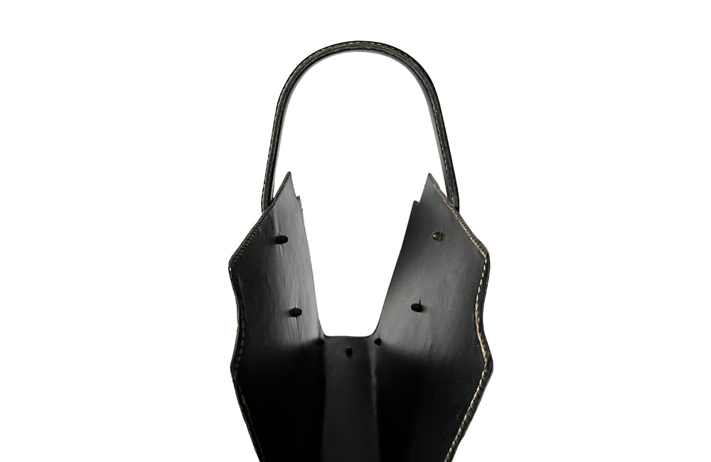 20th century stitched black leather with brass studs magazine holder by Jacques Adnet.