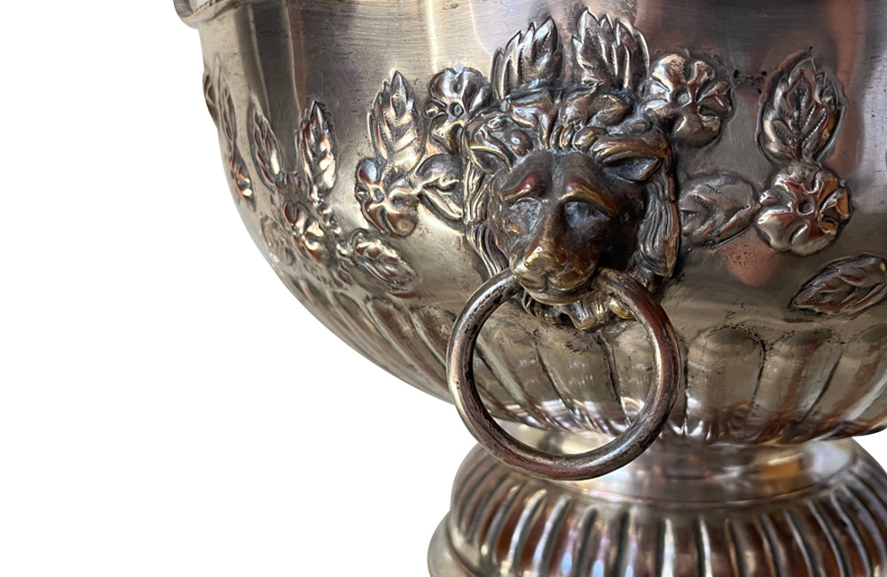 Early 20th Century English nicely worn silverplate footed punch bowl or champagne cooler with lion head ring handles and gadroon rim.