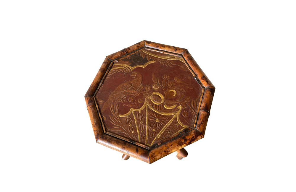 Aesthetic Movement bamboo occasional table with leathered Chinoiserie top embossed with a parrot, floral and foliate decoration. Circa 1900