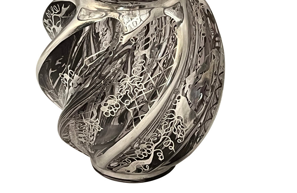 Beautiful mid century crystal vase with silver overlay by the renown French glass makers Saint Graal of swirl form decorated with grape vine and trellis motifs.