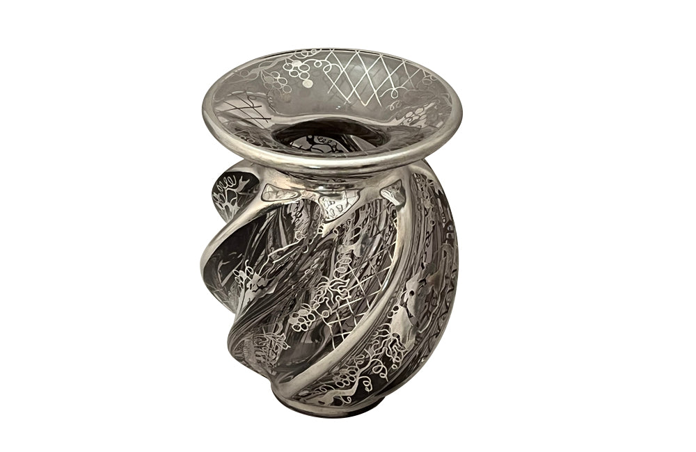 Beautiful mid century crystal vase with silver overlay by the renown French glass makers Saint Graal of swirl form decorated with grape vine and trellis motifs.