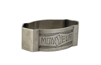 20th Century French silverplate napkin ring engraved 'Monsieur' with stylised garland above and below.