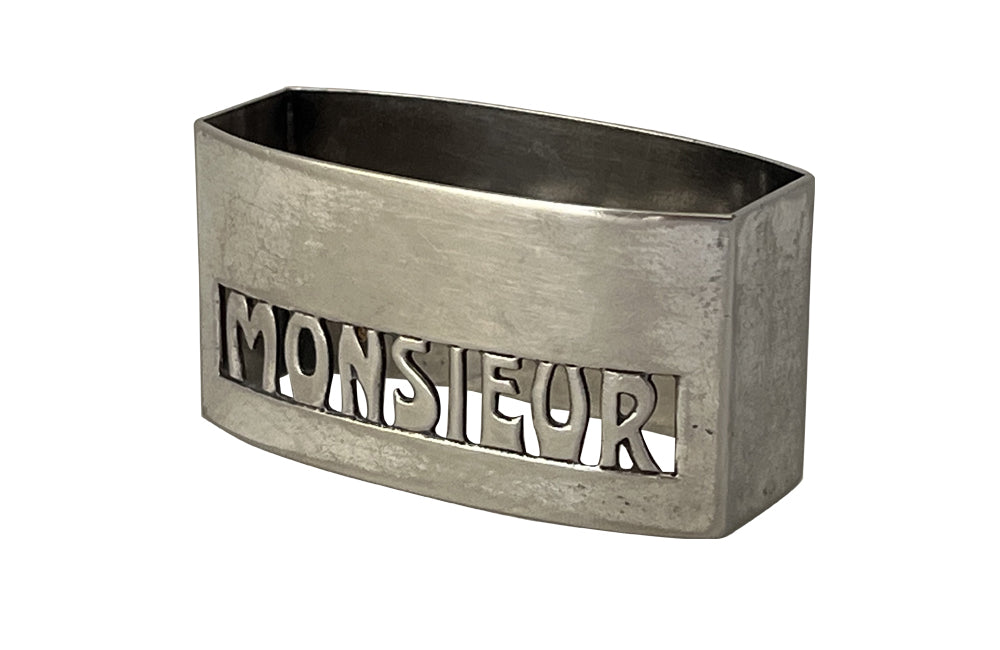20th Century French silverplate napkin ring with cut-out 'Monsieur' lettering.