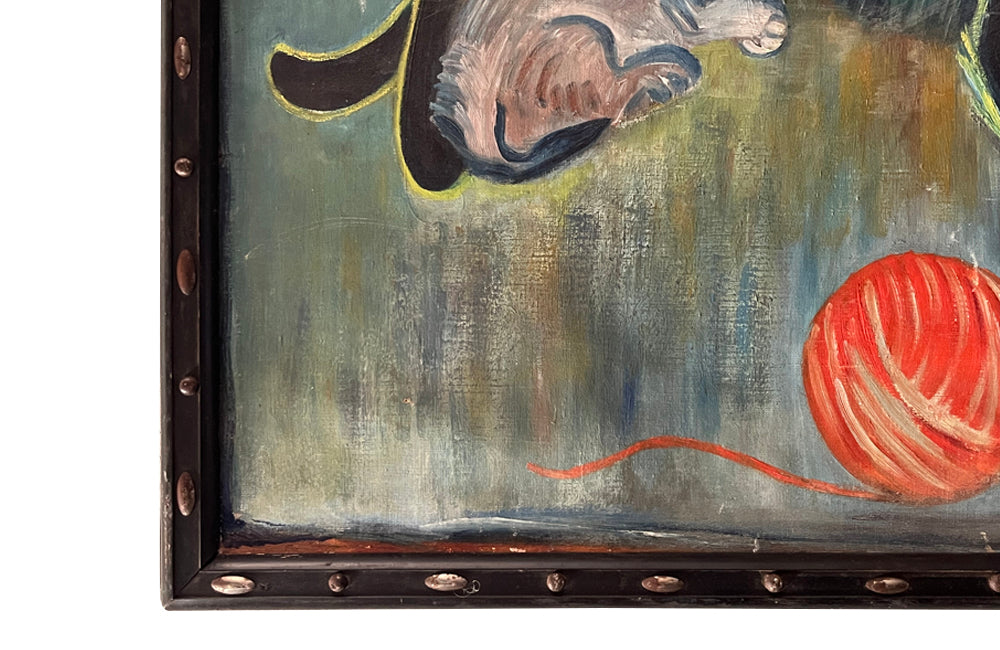 Large 20th Century framed oil on canvas painting of a reclining black cat with her kitten and a ball of wool on a table. 