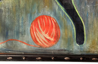 Large 20th Century framed oil on canvas painting of a reclining black cat with her kitten and a ball of wool on a table.