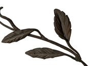 Beautiful pair of early 20th century French large hand wrought iron wall decorations with floral and foliate ornamentation, each in the form of a branching flowering plant.