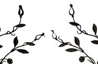 Beautiful pair of early 20th century French large hand wrought iron wall decorations with floral and foliate ornamentation, each in the form of a branching flowering plant.