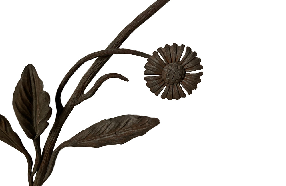 Beautiful pair of early 20th century French large hand wrought iron wall decorations with floral and foliate ornamentation, each in the form of a branching flowering plant.