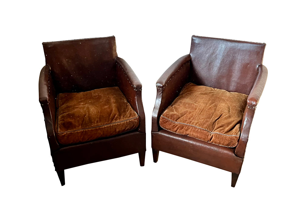 Charming little pair of club chairs with their origianl feather filled cushions circa 1920