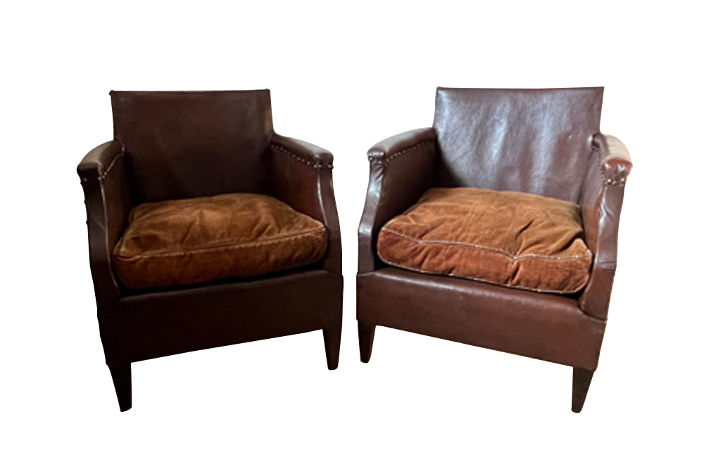 Charming little pair of club chairs with their origianl feather filled cushions circa 1920