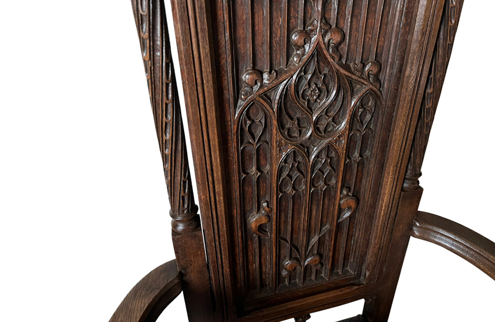 Pair of tall French oak ornately carved armchairs in the Neo-Gothique style.