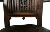 Pair of tall French oak ornately carved armchairs in the Neo-Gothique style.