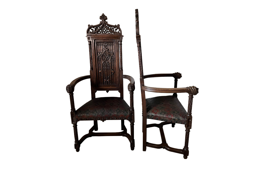 Pair of tall French oak ornately carved armchairs in the Neo-Gothique style.