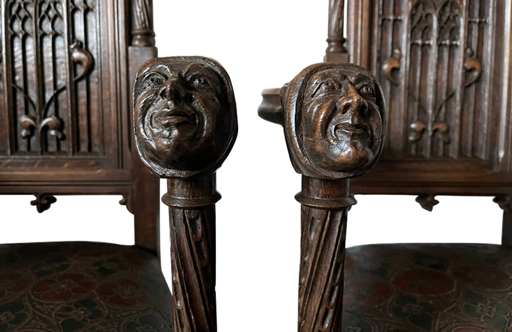 Pair of tall French oak ornately carved armchairs in the Neo-Gothique style.