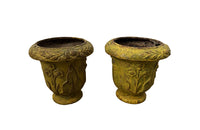 Pair of charming early 20th century French small cast iron urns decorated with daisies and leaves