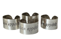 Set of four decorative napkin holders with Bon Appétit inscribed to each.